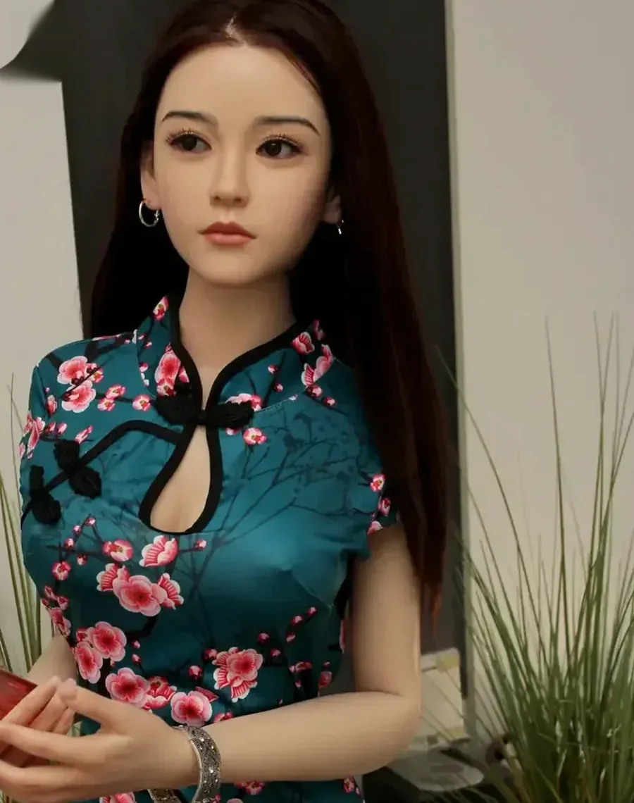 Realistic doll in a teal floral qipao dress